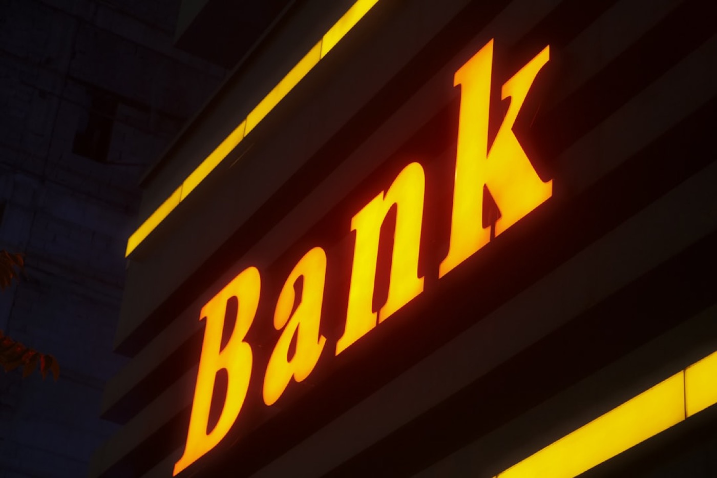 A bank sign lit up at night