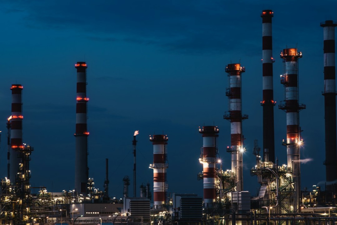 Oil refinery tower lit up at night