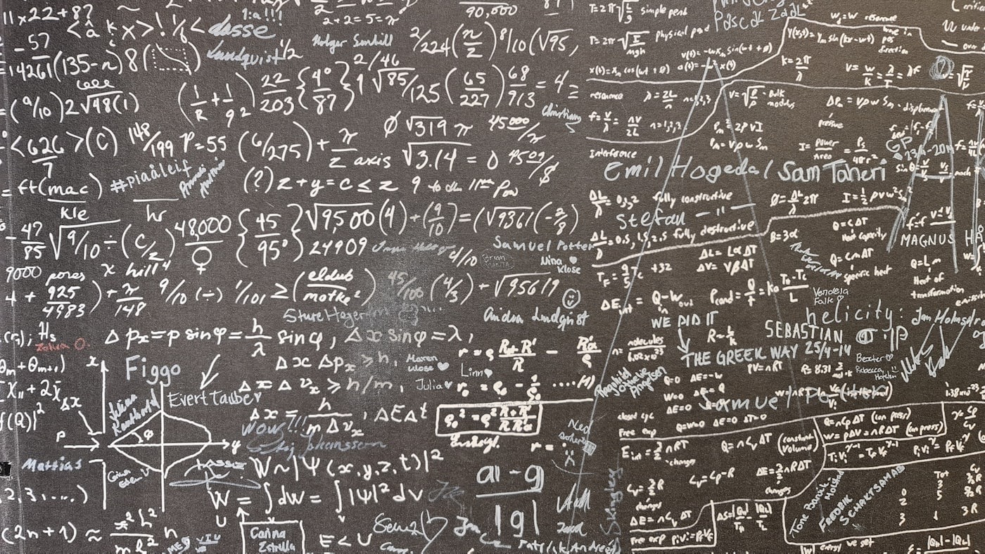Mathematical equations on a board, representing trading expectancy and the law of large numbers